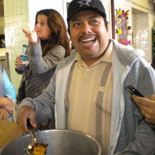 Local resident with ingredients to grind into mole at the tortilleria